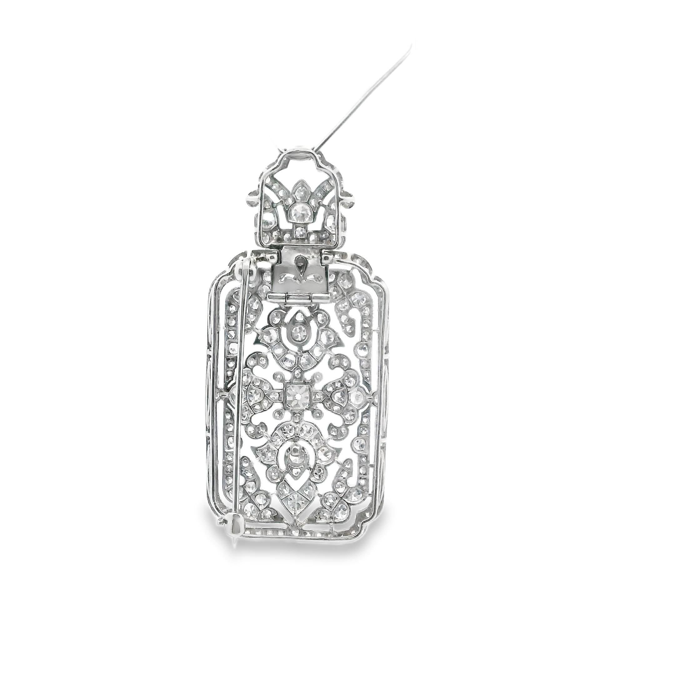 A brooch - pendant with an arabesque motif in 950 platinum set with 8x8 cuts