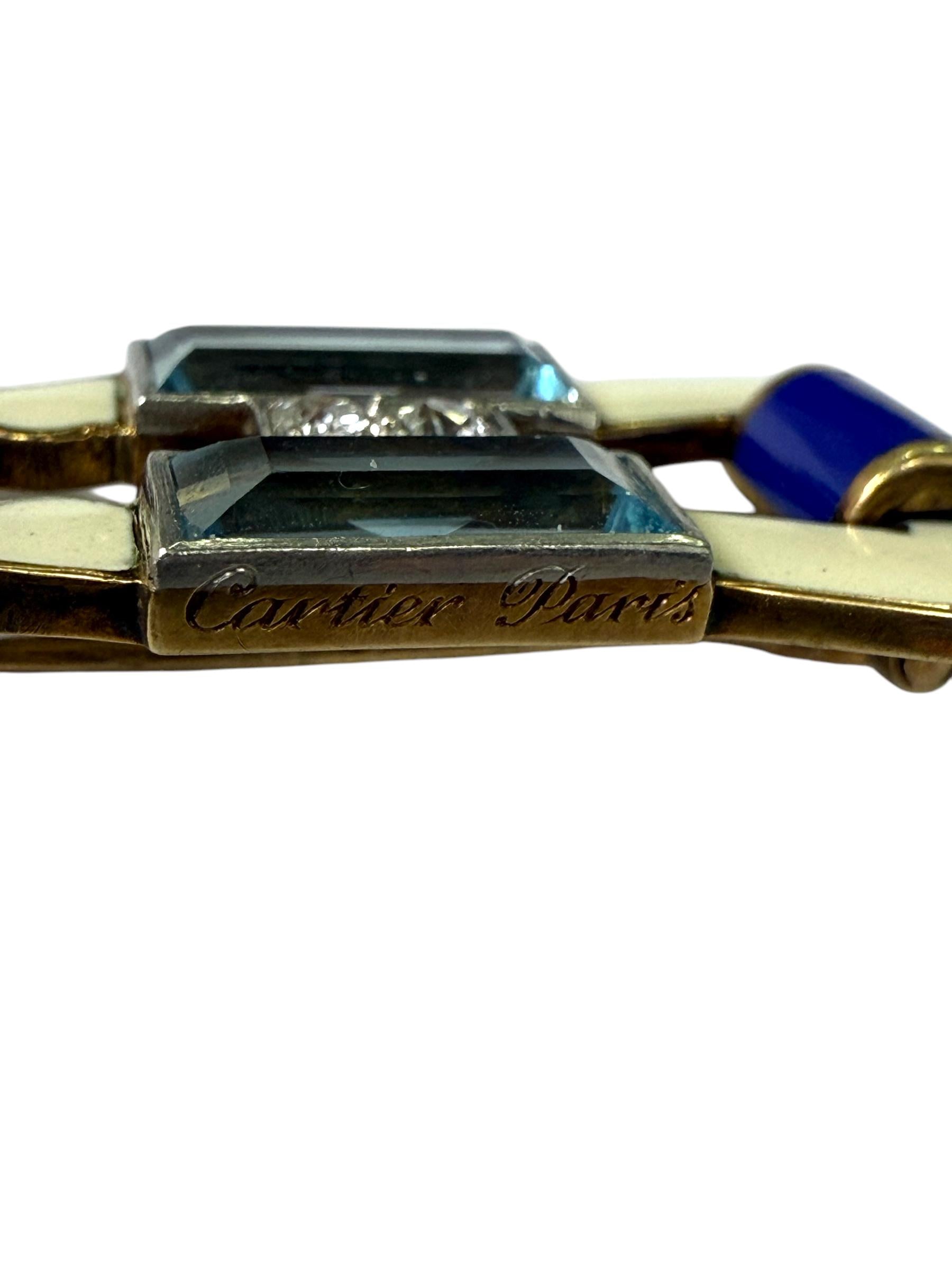 A gold and white and blue enamel brooch set with diamonds and aquamarine.