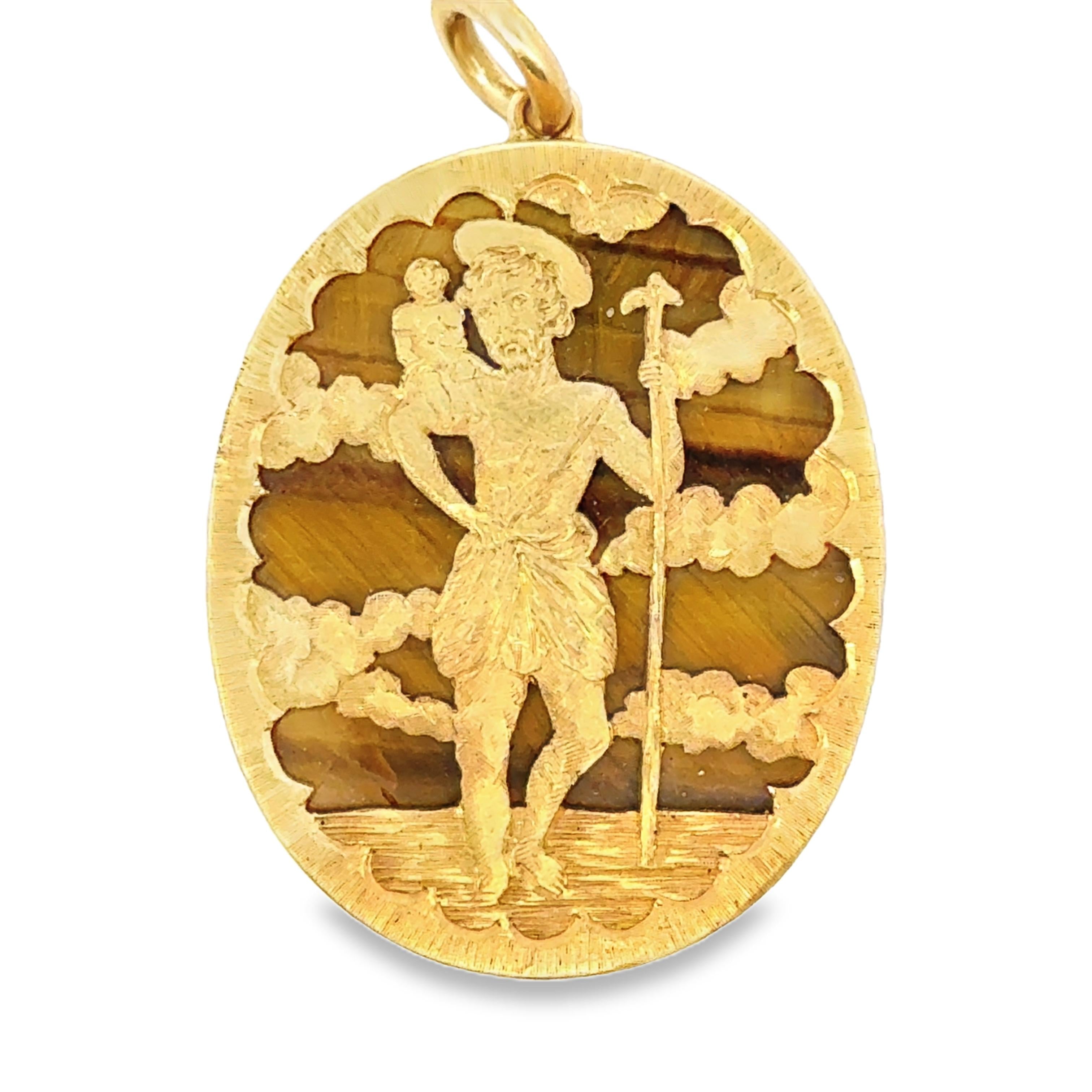 A yellow gold medal pendant with the image of Saint Christopher