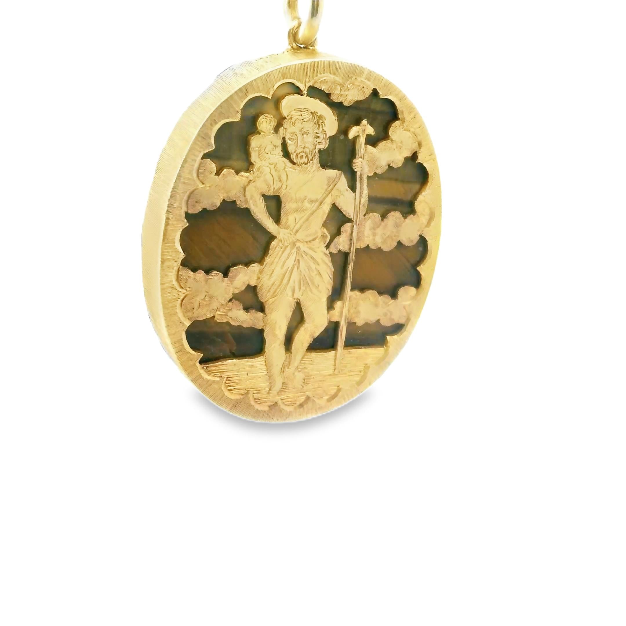 A yellow gold medal pendant with the image of Saint Christopher