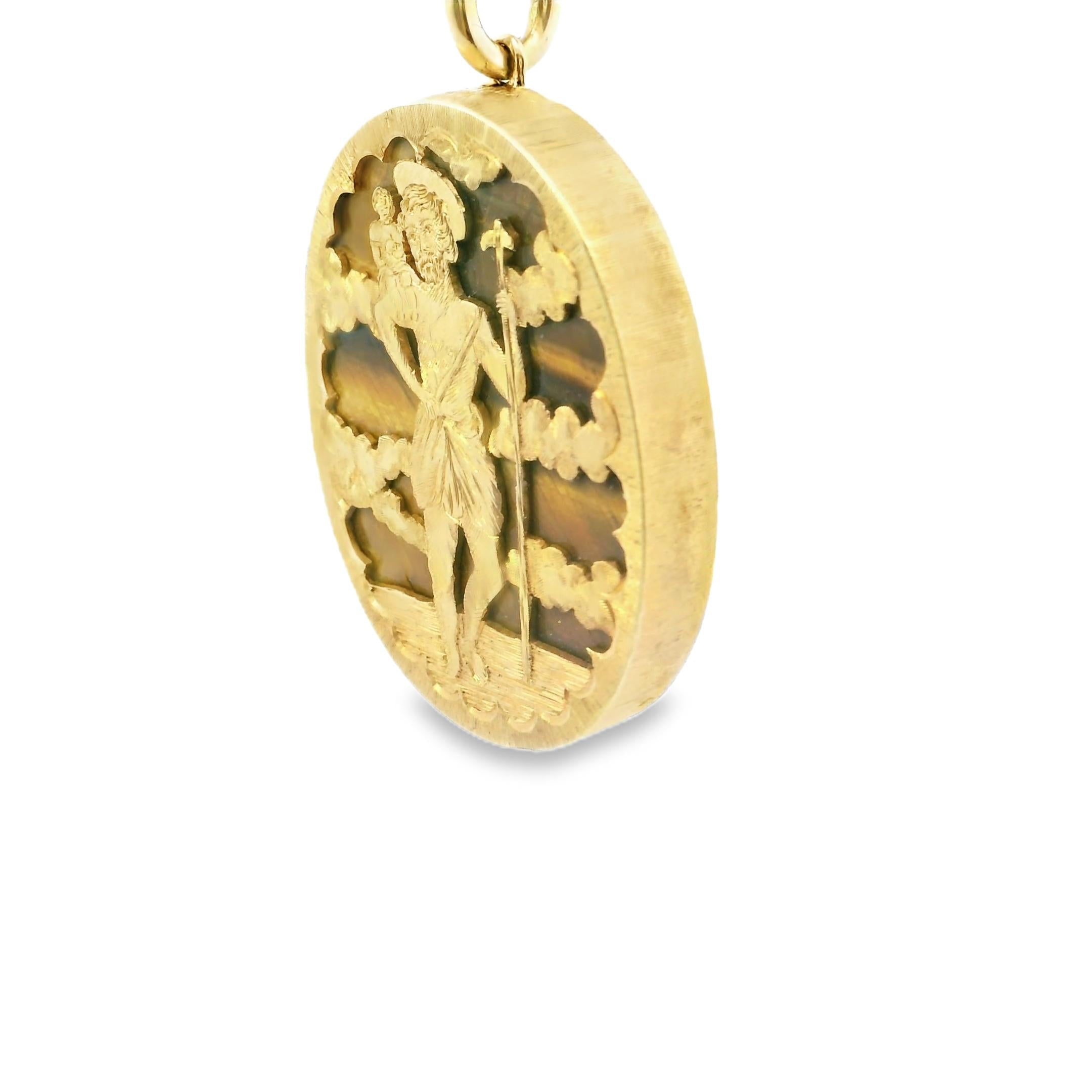 A yellow gold medal pendant with the image of Saint Christopher