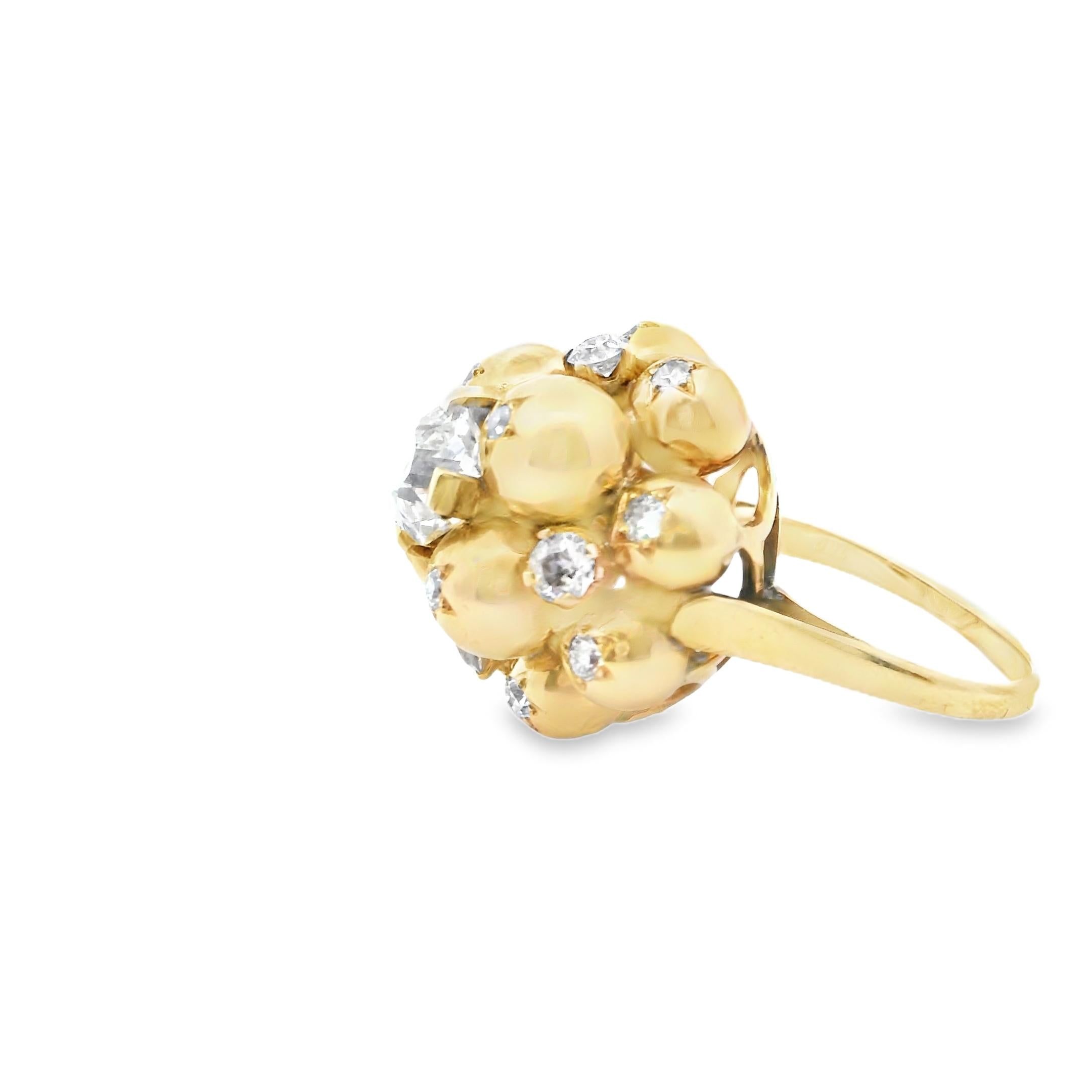 A 18K Yellow Gold ring composed of 12 balls star-set with old-cut diamonds