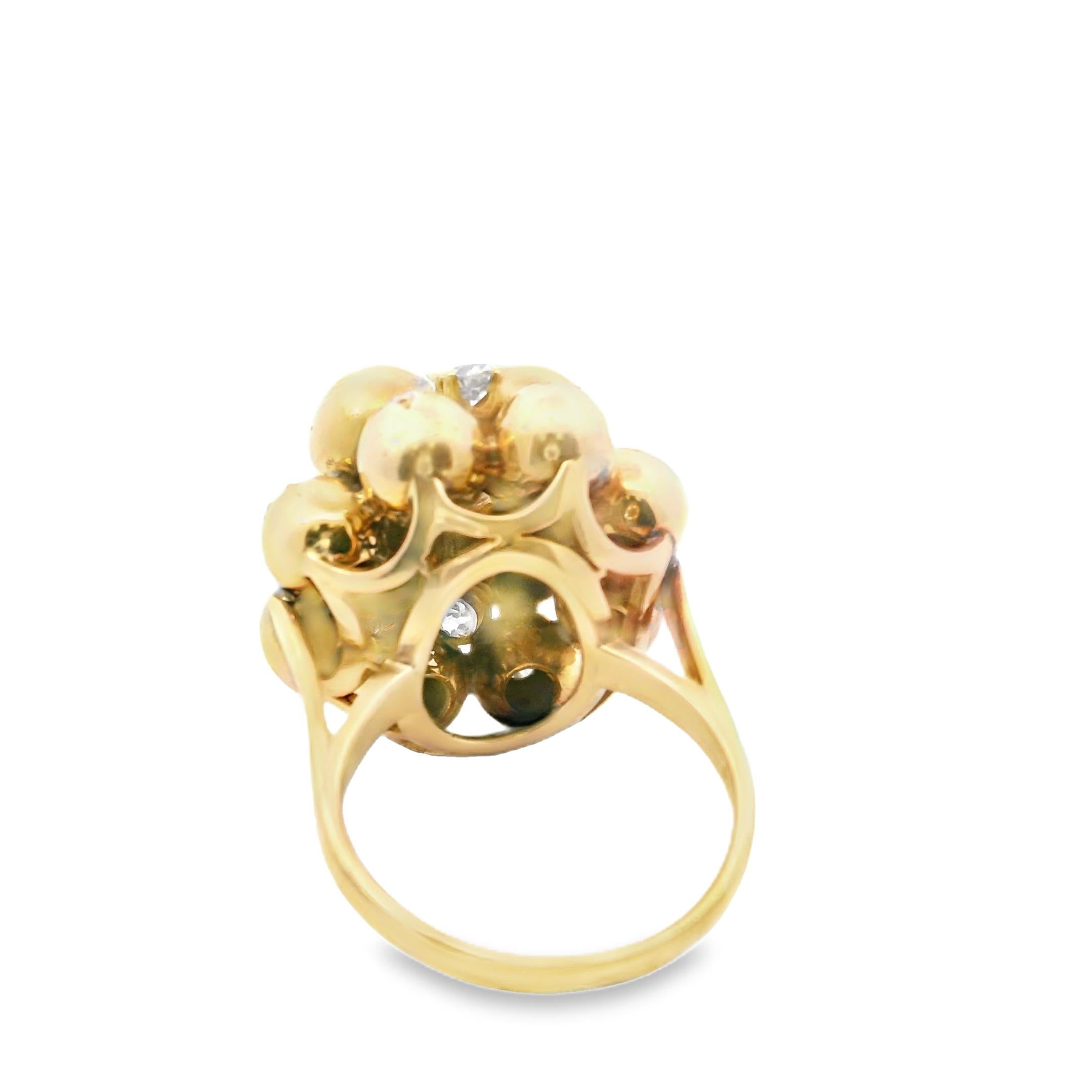 A 18K Yellow Gold ring composed of 12 balls star-set with old-cut diamonds