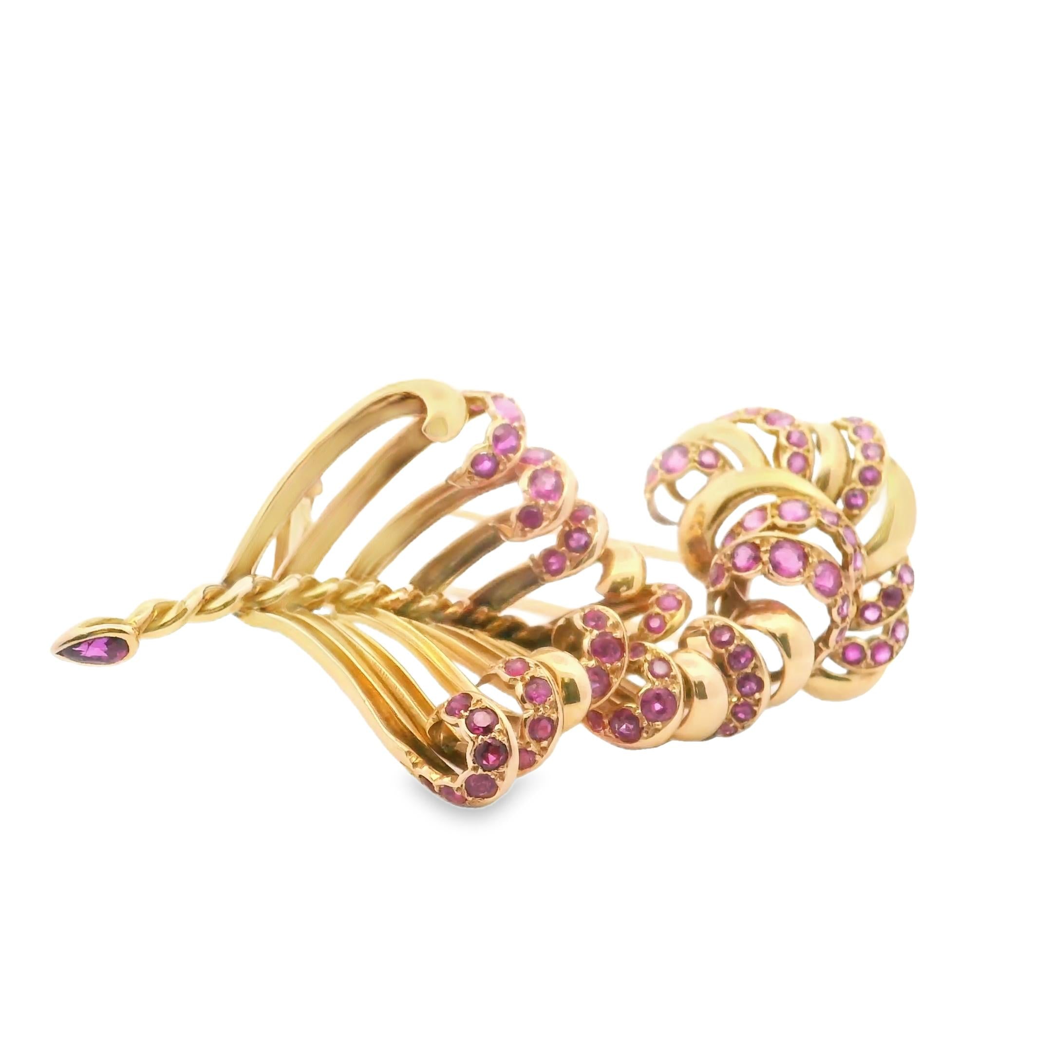 A brooch in gold and pink sapphire