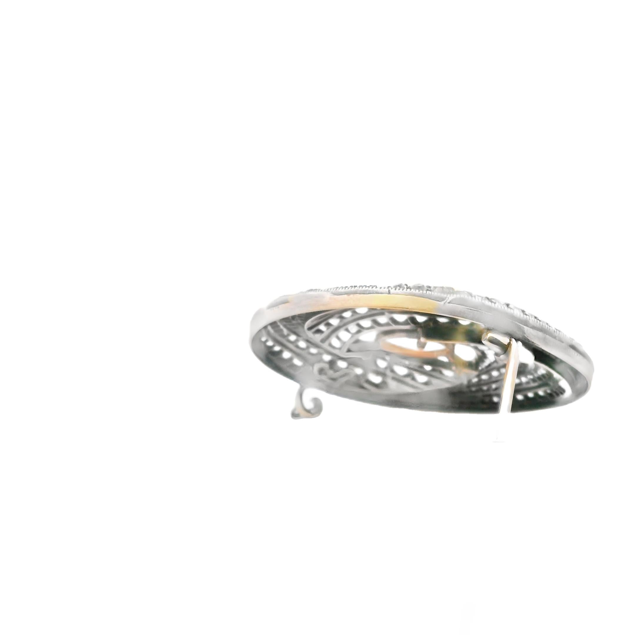A brooch in gold, silver, diamond and moonstone