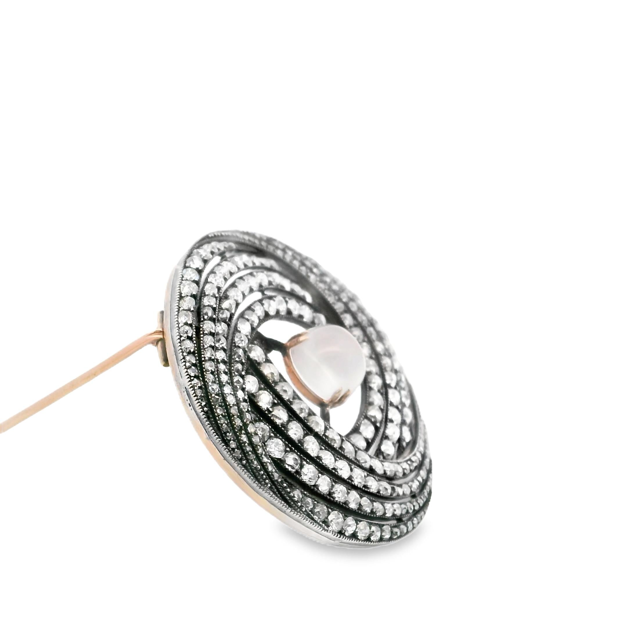 A brooch in gold, silver, diamond and moonstone