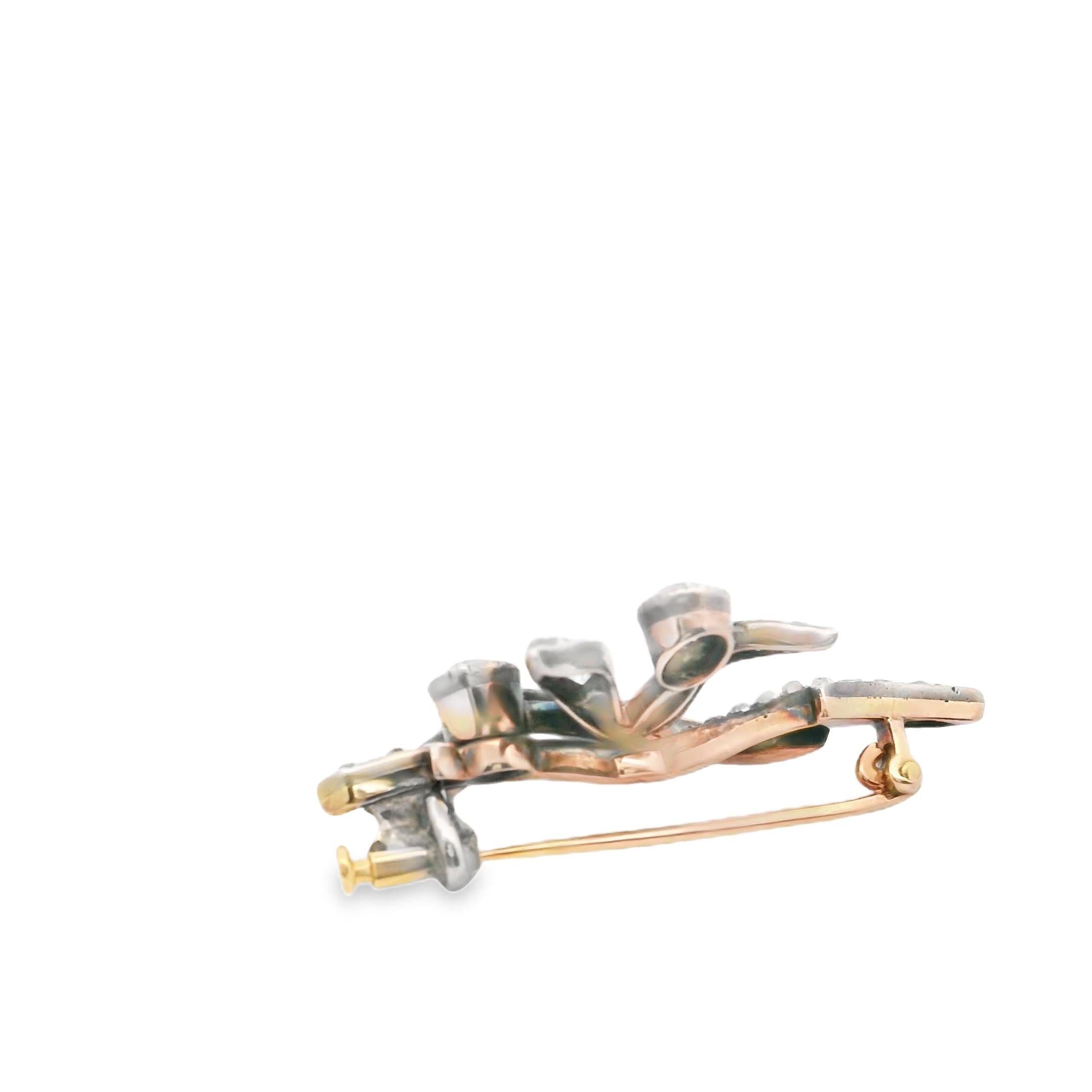 An antique brooch in gold, silver and diamond