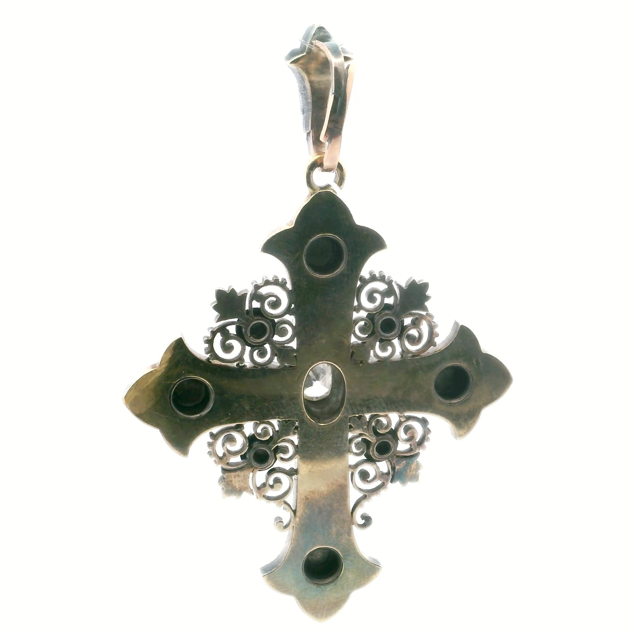 An antique cross in gold, silver, enamel and diamond.