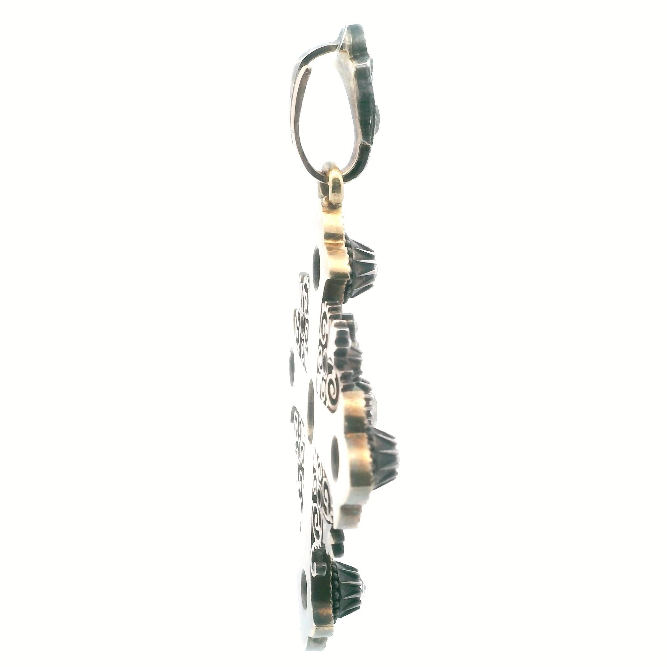 An antique cross in gold, silver, enamel and diamond.