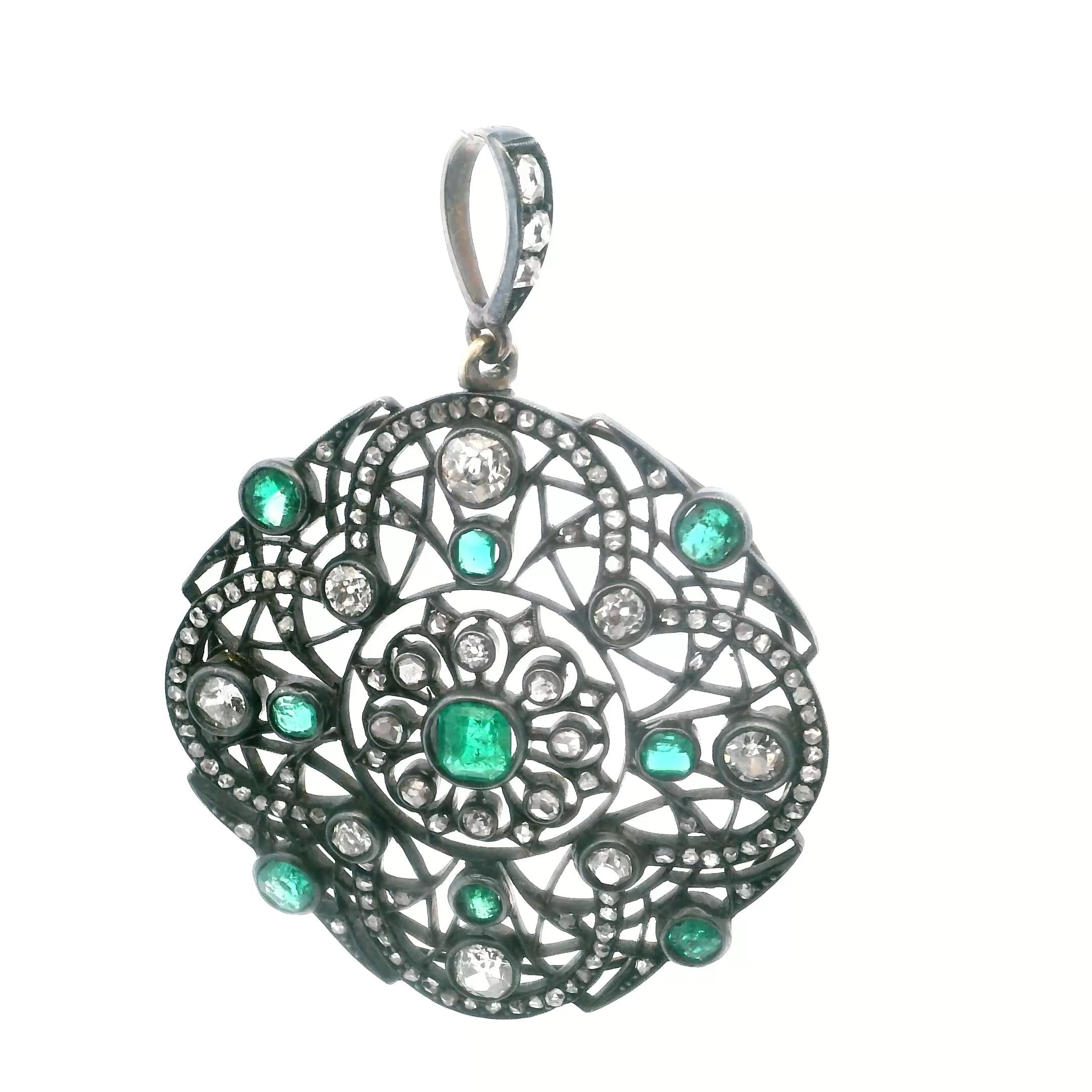 A pendant in gold, silver, diamond and emerald.