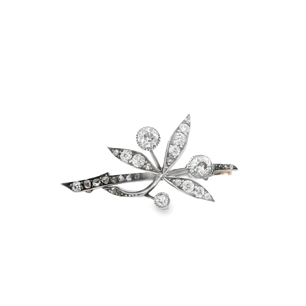 An antique brooch in gold, silver and diamond