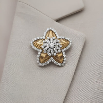 A brooch in gold, platinum and diamond By Cuzi
