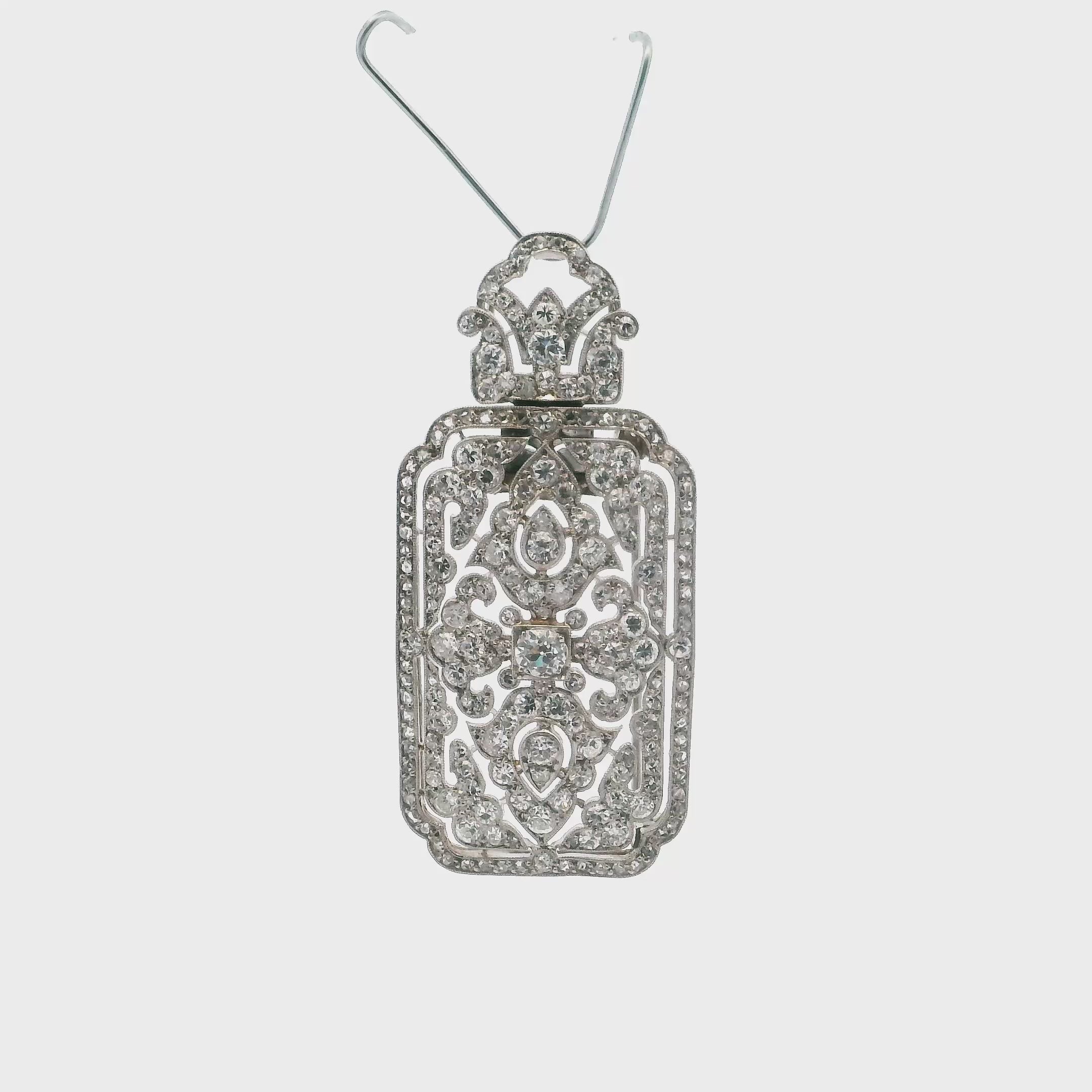 A brooch - pendant with an arabesque motif in 950 platinum set with 8x8 cuts
