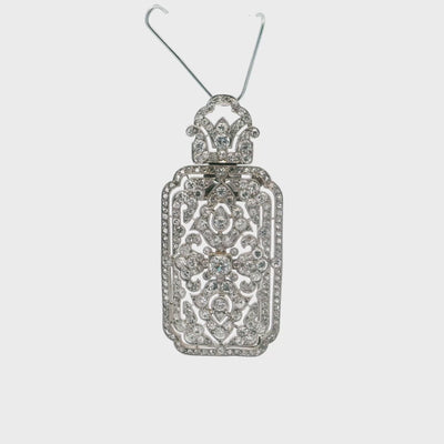 A brooch - pendant with an arabesque motif in 950 platinum set with 8x8 cuts