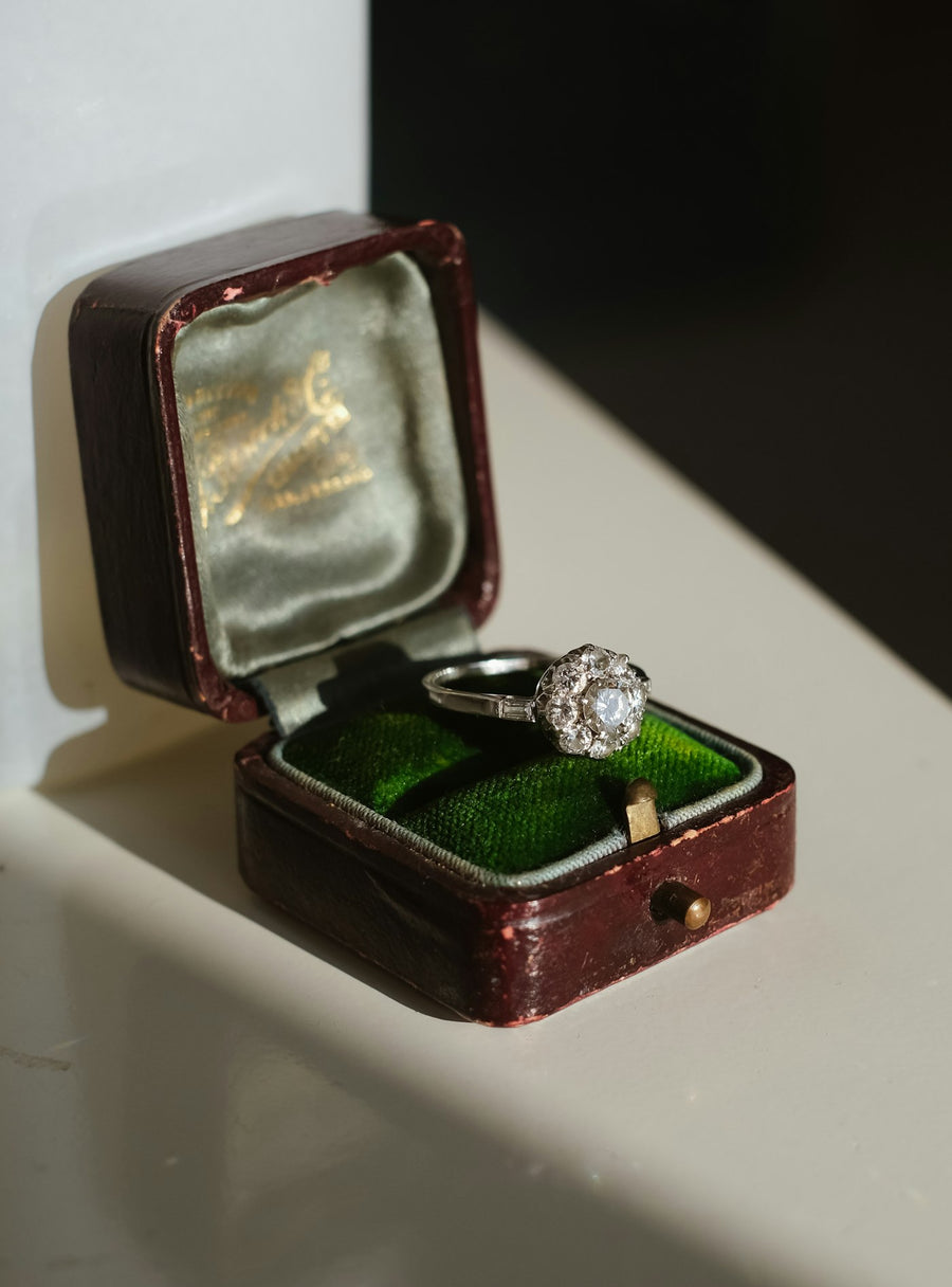 An antique diamond solitaire in its original leather ring box